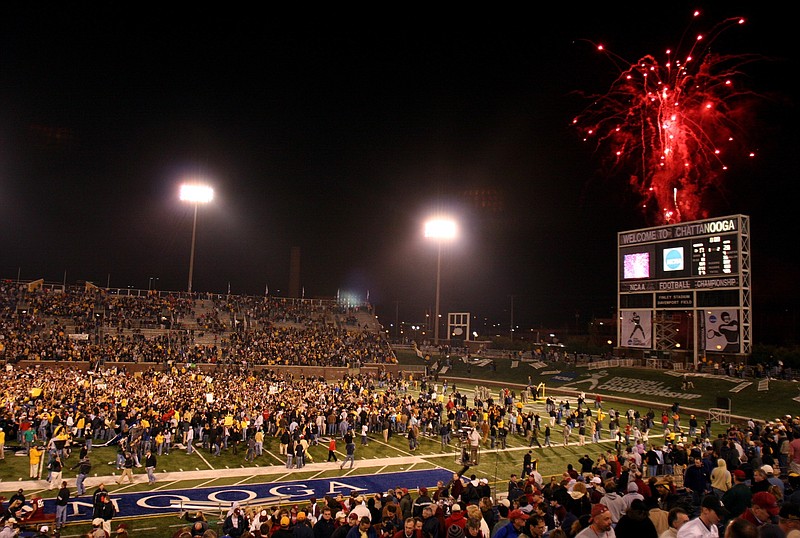 Staff photo / Appalachian State football fans rush the field at Finley Stadium as fireworks go off after the Mountaineers beat Massachusetts 28-17 in the FCS title game on Dec. 15, 2006. Finley Stadium hosted the championship game for the lower tier of NCAA Division I football from 1997 to 2009.