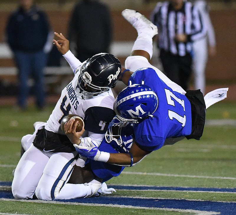 Staff photo by Matt Hamilton / McCallie's Aaron Crowder (17) and Kenzy Paul, obscured, sack Pope John Paul II's Kenny Minchey in a TSSAA Division II-AAA semifinal on Nov. 19 at McCallie.