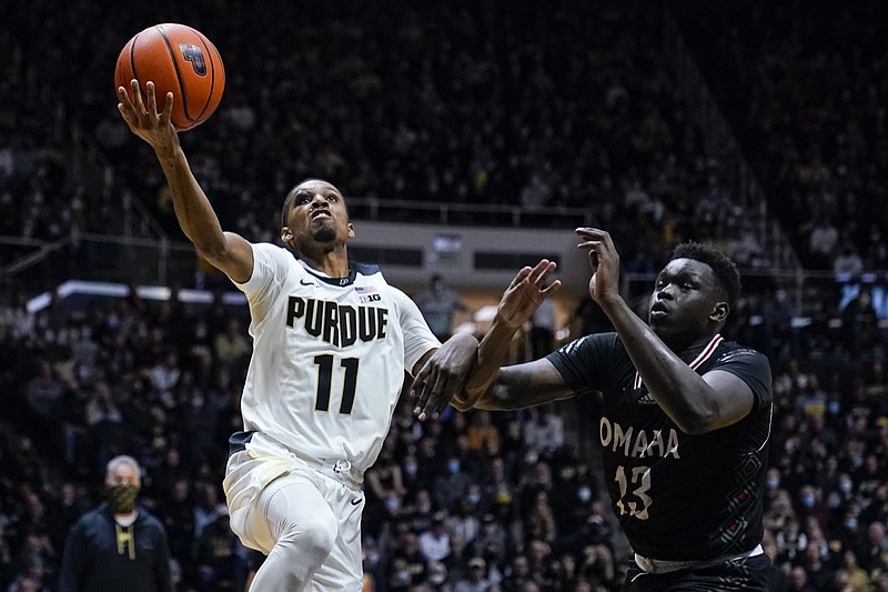 Purdue's Isaiah Thompson (11) shoots over Omaha's Wanjang Tut (13) during the second half of an NCAA college basketball game in West Lafayette, Ind., Friday, Nov. 26, 2021. Purdue defeated Omaha 97-40. (AP Photo/Michael Conroy)