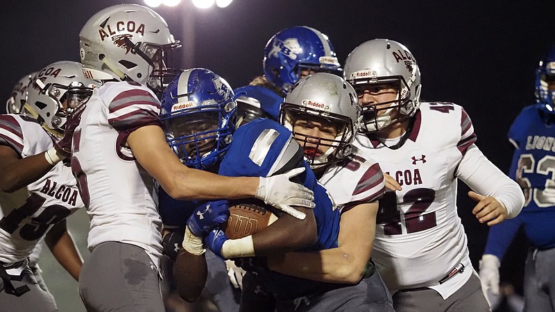 Staff photo / Alcoa's defense swarms to the ball during a playoff game at Red Bank in November 2020. Alcoa has shut out seven of its past eight opponents this season to return to the BlueCross Bowl and continue the bid for its seventh straight state title.