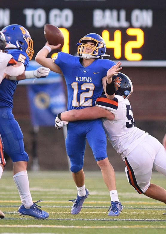 Staff Photo by Matt Hamilton / Donelson Christian Academy (12) Bradford Gaines gets a pass off as he is hit on Thursday, December 2, 2021 at Finley Stadium. Nashville Christian School and Donelson Christian Academy played in the Division II Class A state championship game Thursday.