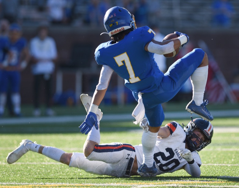 Staff Photo by Matt Hamilton / Donelson Christian Academy (7) Nathan Magalei carries the ball as Nashville Christian School (20) Logan Page trips him up on Thursday, December 2, 2021 at Finley Stadium. Nashville Christian School and Donelson Christian Academy played in the Division II Class A state championship game Thursday.