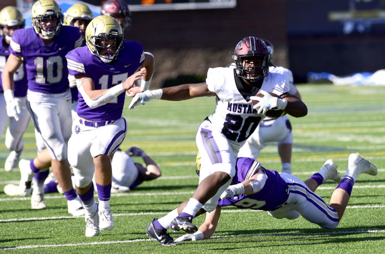 Staff Photo by Robin Rudd / Lipscomb's Alexander Broome is chased by Lion defenders. Broome was the game's MVP. The Lipscomb Academy Mustangs defeated the Christ Presbyterian Academy Lions 27 to 0 to win the TSSAA Division II Class AA state football championship in the BlueCross Bowl held at Finley Stadium.