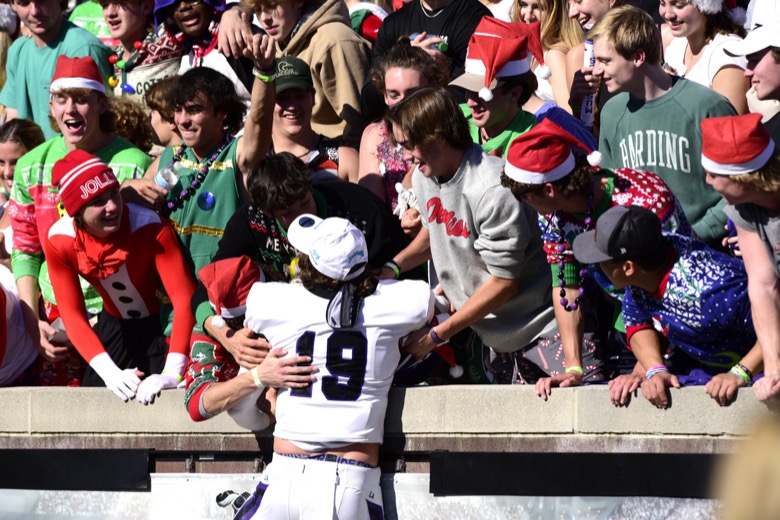 Staff Photo by Robin Rudd / Adam Walker (19) leaps up into the Mustang student section. The Lipscomb Academy Mustangs defeated the Christ Presbyterian Academy Lions 27 to 0 to win the TSSAA Division II Class AA state football championship in the BlueCross Bowl held at Finley Stadium.