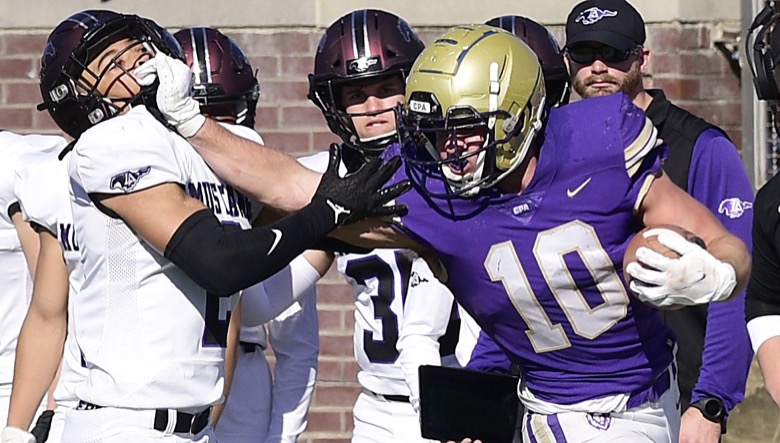 Staff Photo by Robin Rudd / CPA's Langston Patterson (10) stiff arms Lipscomb's Jaden Lyles (2). The Lipscomb Academy Mustangs defeated the Christ Presbyterian Academy Lions 27 to 0 to win the TSSAA Division II Class AA state football championship in the BlueCross Bowl held at Finley Stadium.