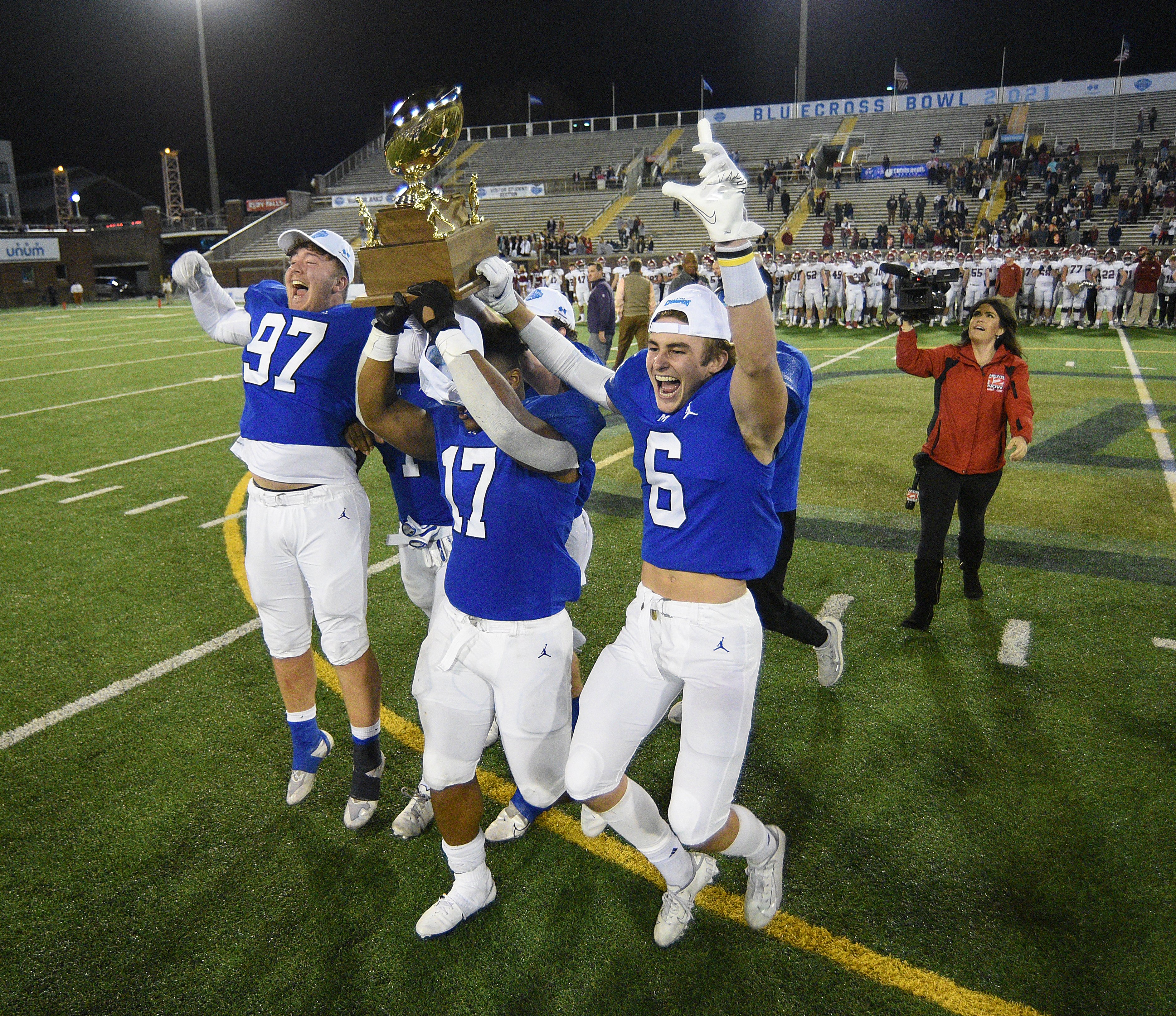 Staff Photo by Matt Hamilton / McCallie School (97) Thomas Pilon, (17) Aaron Crowder and (6) Austin Breedlove carry the trophy to their waiting teammates on Thursday, December 2, 2021 at Finley Stadium. McCallie School played Montgomery Bell Academy in the Division II Class AAA State Football Playoffs on Thursday.