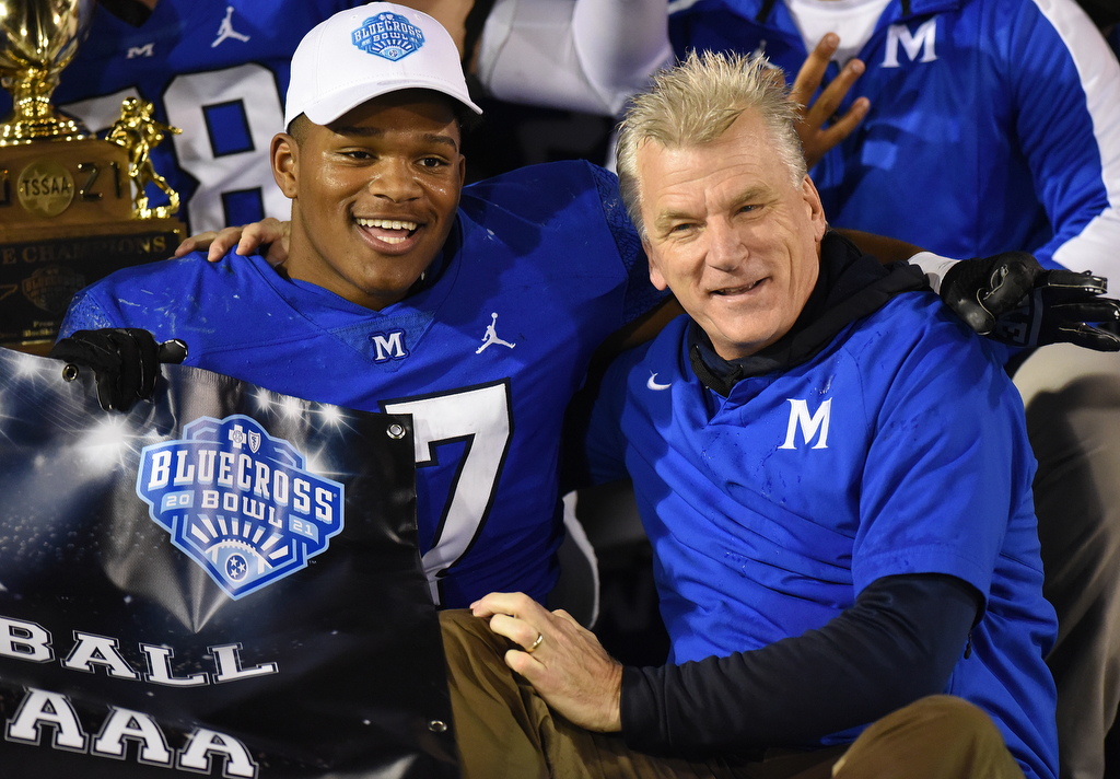 Staff Photo by Matt Hamilton / McCallie School (17) Aaron Crowder celebrates with coach Ralph Potter after their win on Thursday, December 2, 2021 at Finley Stadium. McCallie School played Montgomery Bell Academy in the Division II Class AAA State Football Playoffs on Thursday.
