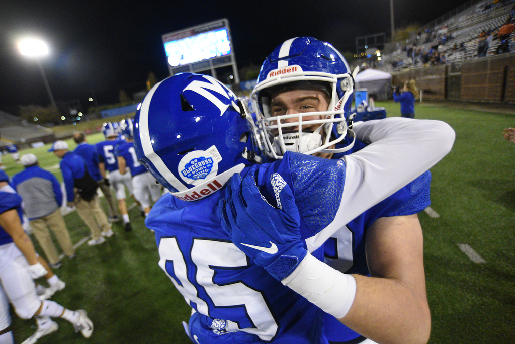 Staff Photo by Matt Hamilton / McCallie School (72) Eliot Guay hugs a teammate after the victory on Thursday, December 2, 2021 at Finley Stadium. McCallie School played Montgomery Bell Academy in the Division II Class AAA State Football Playoffs on Thursday.