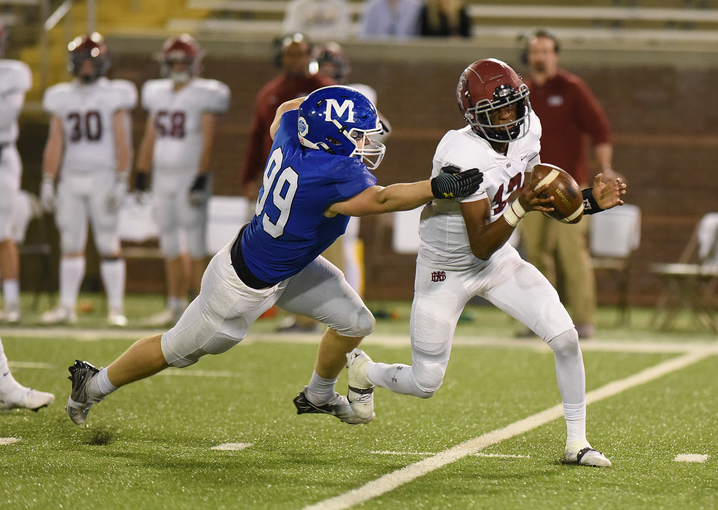 Staff Photo by Matt Hamilton / McCallie School (99) Jay Williams sacks Montgomery Bell Academy (12) Marcel Reed on Thursday, December 2, 2021 at Finley Stadium. McCallie School played Montgomery Bell Academy in the Division II Class AAA State Football Playoffs on Thursday.