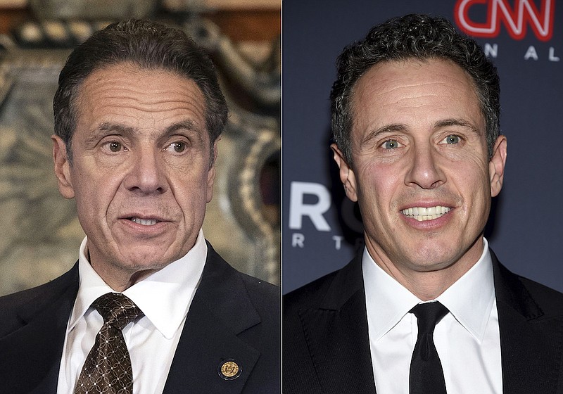In this combination of photos New York Gov. Andrew Cuomo, left, appears during a news conference about COVID-19 at the State Capitol in Albany, N.Y., on Dec. 3, 2020, and his brother CNN anchor Chris Cuomo attends the 12th annual CNN Heroes: An All-Star Tribute at the American Museum of Natural History in New York on Dec. 9, 2018. CNN said Tuesday, Nov. 30, 2021, it was suspending Chris Cuomo indefinitely after details emerged about how he helped his brother, as he faced charges of sexual harassment.(Mike Groll/Office of Governor of Andrew M. Cuomo via AP, left, and Evan Agostini/Invision/AP, File)