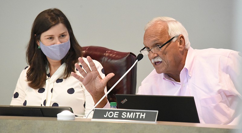 Staff File Photo by Matt Hamilton / School board member Jenny Hill looks on as fellow member Joe Smith speaks during an August Hamilton County Board of Education meeting.