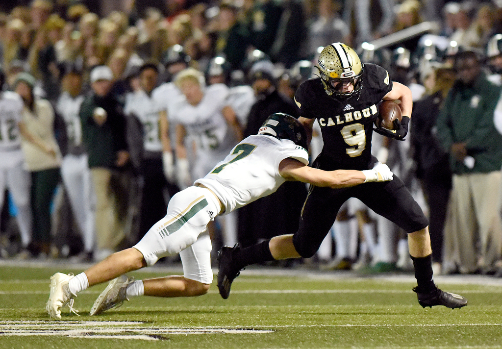 Staff Photo by Matt Hamilton / Calhoun High (9) Quin Smith breaks a tackle attempt by Blessed Trinity (7) Ryan Combs after making a catch on Friday, December 3, 2021 in Calhoun, Ga. Calhoun High hosted Blessed Trinity in a GHSA Class 5A football semifinal game Friday.