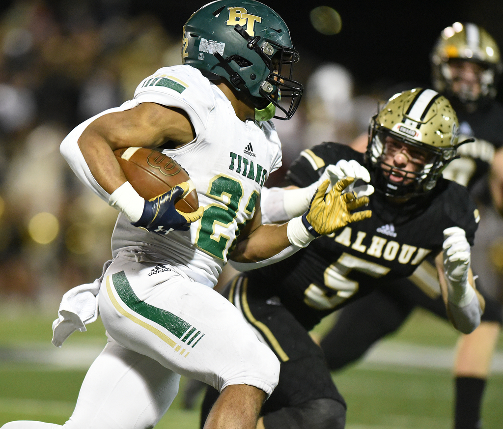 Staff Photo by Matt Hamilton / Calhoun High (5) Cole Speer chases Blessed Trinity (22) Justice Haynes as he carries the ball on Friday, December 3, 2021 in Calhoun, Ga. Calhoun High hosted Blessed Trinity in a GHSA Class 5A football semifinal game Friday.