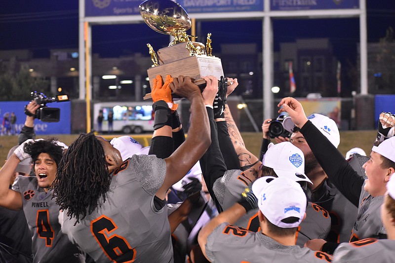 Staff photo by Patrick MacCoon / Powell High School football players lifts the TSSAA Class 5A BlueCross Bowl state championship gold ball trophy into the air after beating Page 42-34 at Finley Stadium on Friday night.