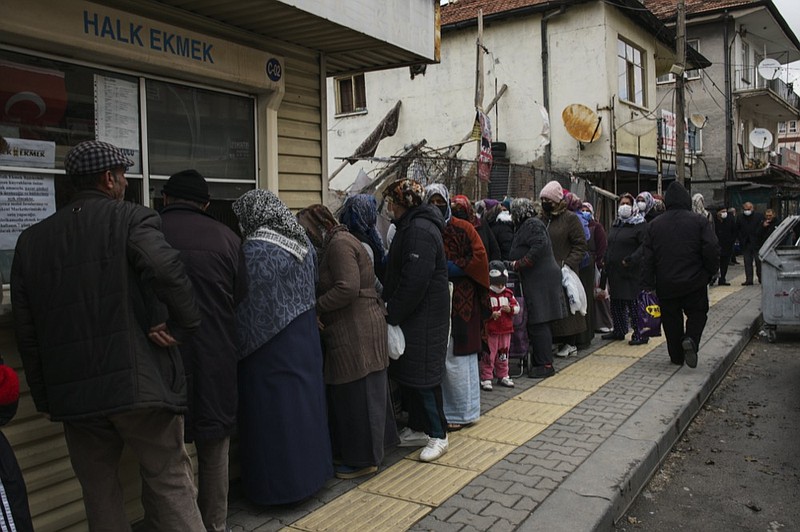 People buy bread in an Ankara Municipality's bread kiosk in Mamak neighbourhood, in Ankara's suburb, Turkey, Wednesday, Dec. 1, 2021. (AP Photo/Burhan Ozbilici)


