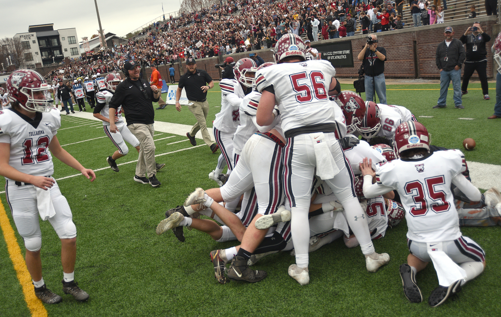 Staff photo by Matt Hamilton / Tullahoma football players pile on Krys Uselton after he intercepted a pass to seal the Wildcats' 21-14 double-overtime victory against Elizabethton in Saturday's TSSAA Class 4A BlueCross Bowl at Finley Stadium.