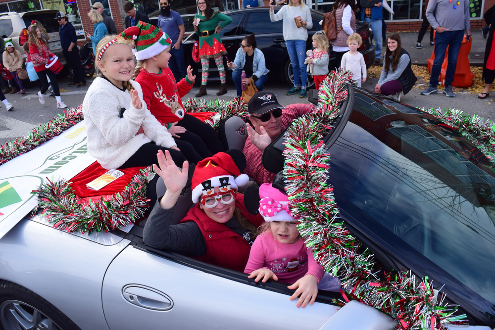 Staff Photo by Robin Rudd / Friends of the Chattanooga Elf pack a Corvette during the parade. The 15th annual MAINx24 EPB Southside Parade and street festival took place on December 4, 2021.