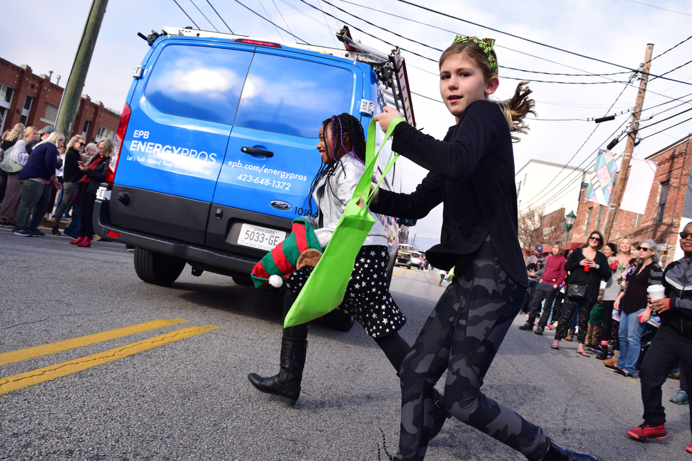 Staff Photo by Robin Rudd / Children dart across the street in search of treats. The 15th annual MAINx24 EPB Southside Parade and street festival took place on December 4, 2021.