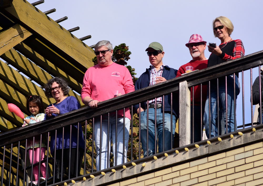 Staff Photo by Robin Rudd / People watch from the rooftops along Main Street. The 15th annual MAINx24 EPB Southside Parade and street festival took place on December 4, 2021.