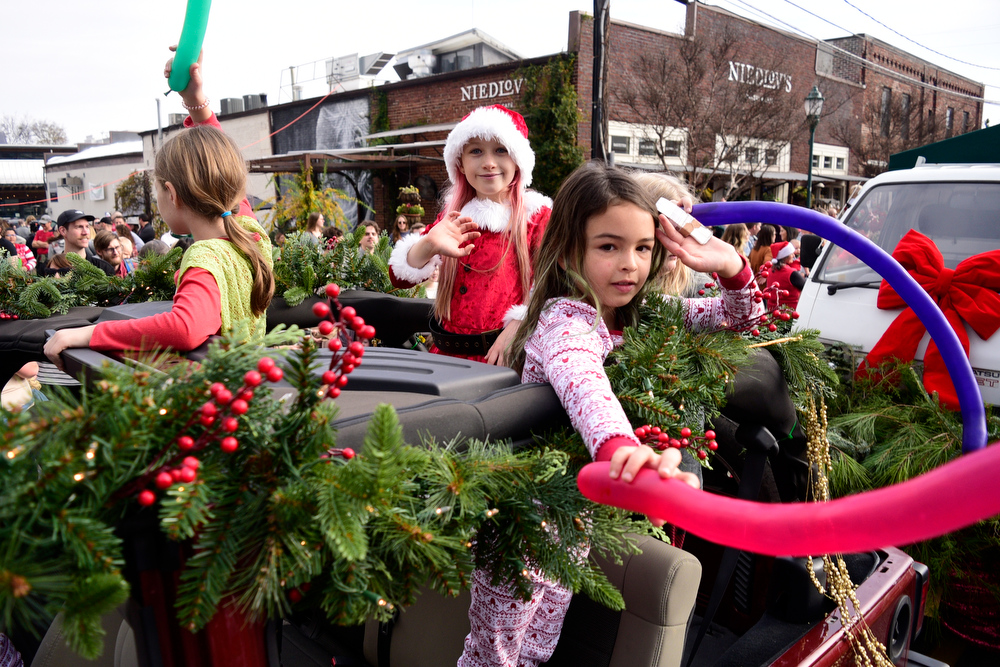 Staff Photo by Robin Rudd / Three young girls ride a evergreen decorated car in the parade. The 15th annual MAINx24 EPB Southside Parade and street festival took place on December 4, 2021.