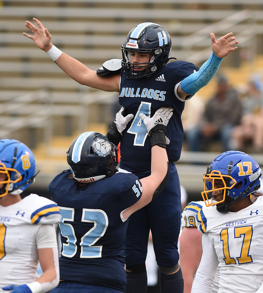 Staff Photo by Matt Hamilton / Hampton High School (52) Andon Winters lifts (4) Conor Jones as they celebrate after an opening-drive score on Saturday, December 4, 2021 at Finley Stadium during the Class 2A championship game. Westview defeated Hampton 55-14 in the championship game.