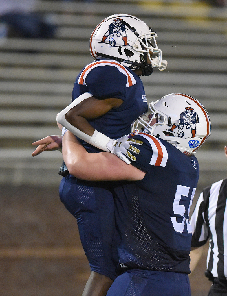 Staff Photo by Matt Hamilton / Oakland High School (55) Zachary Turk lifts (8) Khalil James after a touchdown on Saturday, December 4, 2021 at Finley Stadium during the Class 6A championship game.