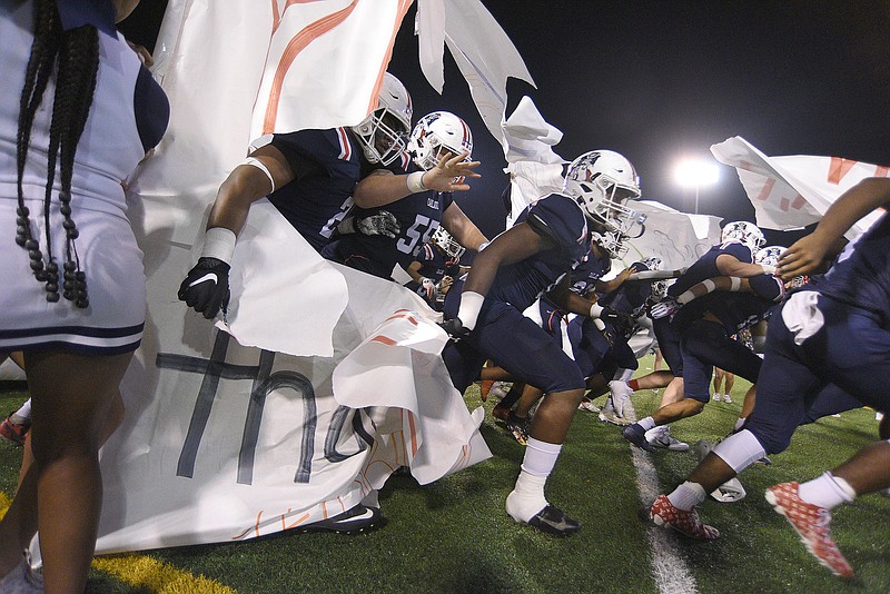 Staff photo by Matt Hamilton /  Oakland football players take the field at Finley Stadium for Saturday night's TSSAA Class 6A BlueCross Bowl against Summit.