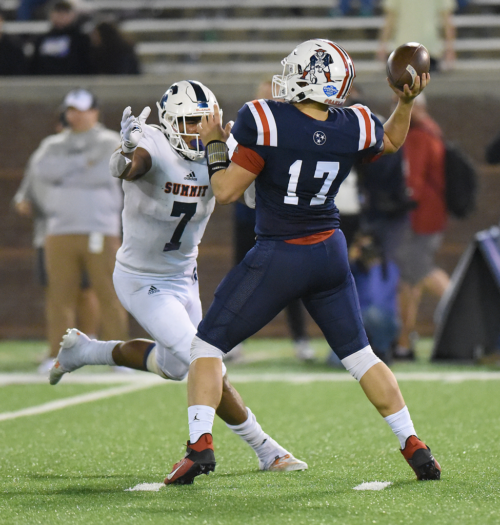 Staff Photo by Matt Hamilton / Oakland High School (17) Kade Hewitt takes the hit from Summit High School (7) Keaton Wade but gets off a touchdown pass on Saturday, December 4, 2021 at Finley Stadium during the Class 6A championship game.
