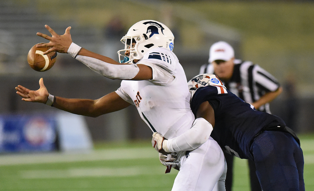 Staff Photo by Matt Hamilton / Oakland High School (6) Dylan King forces a fumble by Summit High School (1) Destin Wade on a two-point conversion attempt on Saturday, December 4, 2021 at Finley Stadium during the Class 6A championship game.