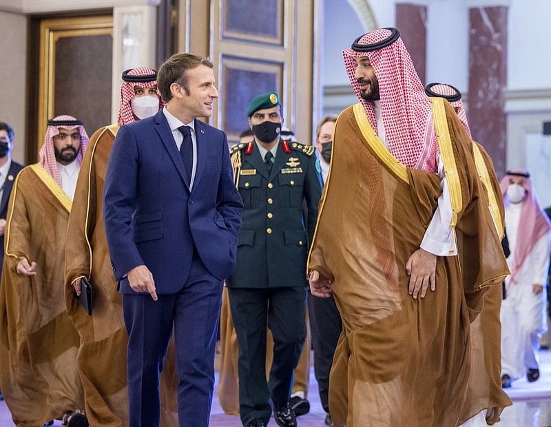 In this photo released by Saudi Royal Palace, Saudi Crown Prince Mohammed bin Salman greets French President Emmanuel Macron, left, upon his arrival in Jiddah, Saudi Arabia, Saturday, Dec. 4, 2021. (Bandar Aljaloud/Saudi Royal Palace via AP)


