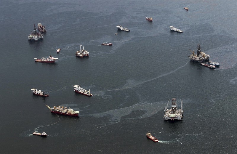 FILE - Drilling rigs and workboats operate at the site of the Deepwater Horizon incident in the Gulf of Mexico Friday, July 16, 2010. (AP Photo/Dave Martin, File)



