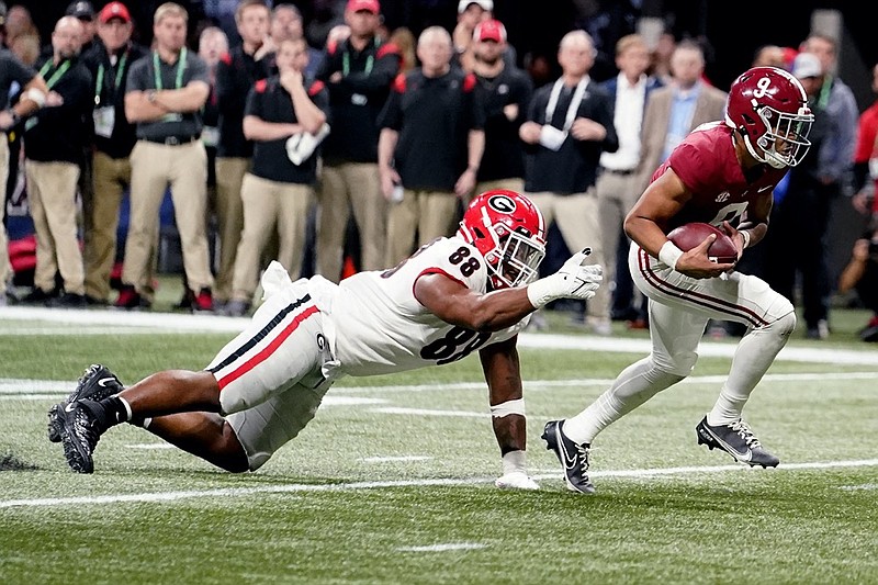 Alabama quarterback Bryce Young (9) runs past Georgia defensive lineman Jalen Carter (88) for a touchdown during the first half of the Southeastern Conference championship NCAA college football game, Saturday, Dec. 4, 2021, in Atlanta. (AP Photo/Brynn Anderson)

