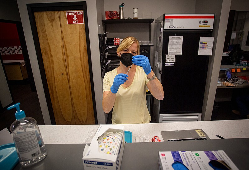Korinne McNally, a registered nurse, prepares the first doses of COVID-19 vaccination for children ages 5-11 at a pediatrician's office on Wednesday in Decatur, Ga. (AP Photo/Ron Harris)