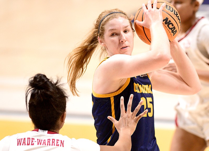 Staff photo by Robin Rudd / UTC's Abbey Cornelius (25) protects the basketball while guarded by Alabama's Khyla Wade-Warren during Sunday's game at McKenzie Arena.