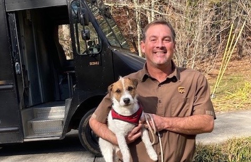 UPS delivery driver Darrell Slack holds on to Pete, a wayward pup he found while doing his rounds in Turtletown on Nov. 29, 2021. He returned Pete to his owners, Paula and Terry Odom, who were delighted to receive the early Christmas present. / Photo courtesy of Darrell Slack

