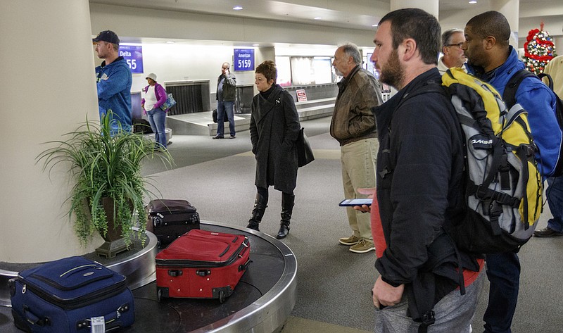 Staff file photo / Travelers wait at the baggage claim area at the Chattanooga Airport in this file photo. Airport officials are accepting bids for the biggest makeover to the passenger terminal in about three decades.