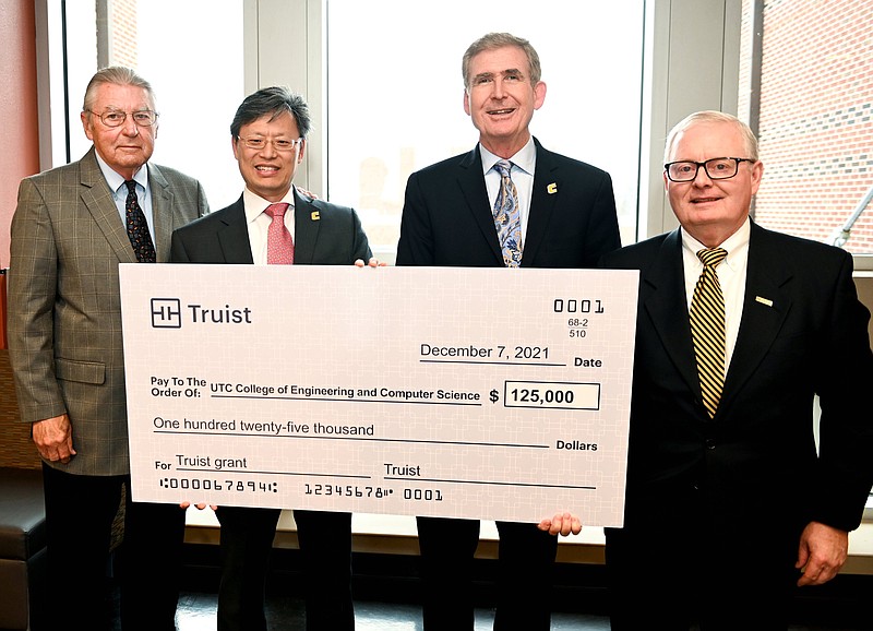 Contributed photo by Angela Foster / Joe Ferguson, Advisory Board Chair, UTC College of Engineering and Computer Science, Dean Daniel Pack, Chancellor Steve Angle and Jim Vaughn, senior Vice President, Market President Tennessee Region, Truist, from left, stand with a check Tuesday, Dec. 4, 2021, in the Engineering and Computer Science building during a celebration of a gift from Truist in support of the University of Tennessee at Chattanooga College of Engineering and Computer Science?s internship program.