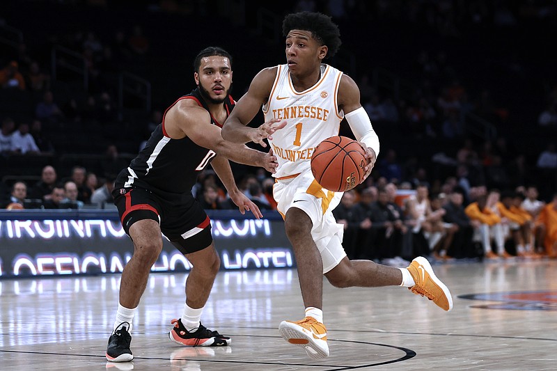 Tennessee guard Kennedy Chandler (1) drives past Texas Tech forward Kevin Obanor during the first half of an NCAA college basketball game in the Jimmy V Classic on Tuesday, Dec. 7, 2021, in New York. (AP Photo/Adam Hunger)