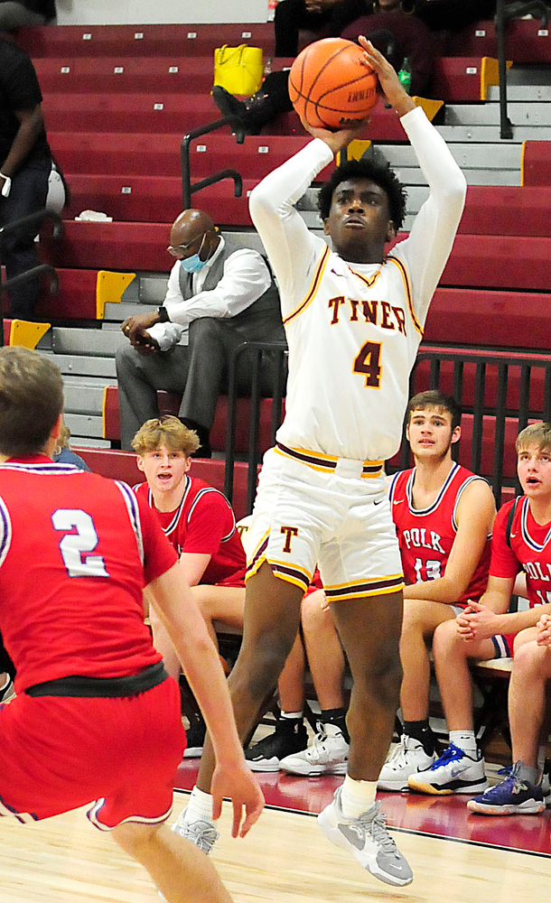 Staff Photo by Robin Rudd / Tyner's Nehemiah Bloodsaw (4) shoots a three-point shot. The Polk County Wildcats visited the Tyner Rams in TSSAA boy's basketball on December 7, 2021.