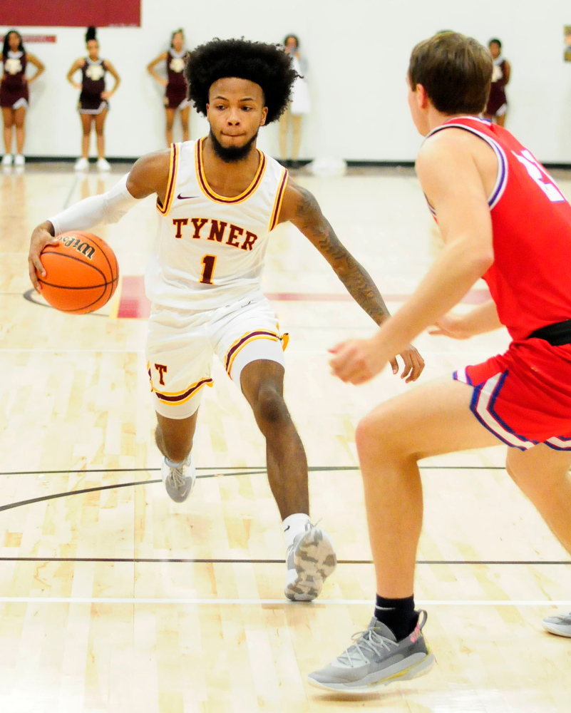 Staff Photo by Robin Rudd / Tyner's Xavier Fisher (1) dribbles past the fouling. The Polk County Wildcats visited the Tyner Rams in TSSAA boy's basketball on December 7, 2021.