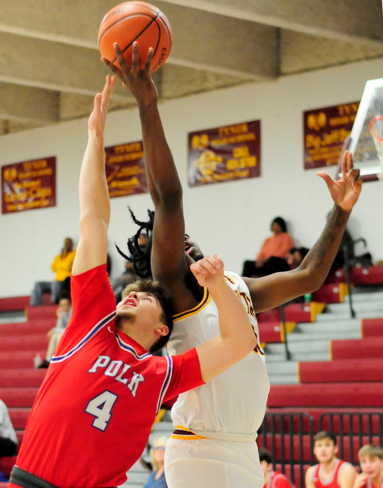 Staff Photo by Robin Rudd / Polk's Noah Shaw (4) and Tyner's Anthony Sims (32) battle for a rebound. The Polk County Wildcats visited the Tyner Rams in TSSAA boy's basketball on December 7, 2021.
