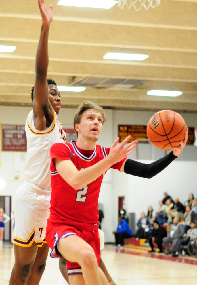 Staff Photo by Robin Rudd / Polk's Caleb Milen (2) drives to the basket as Tyner's Keelan Jackson defends. The Polk County Wildcats visited the Tyner Rams in TSSAA boy's basketball on December 7, 2021.