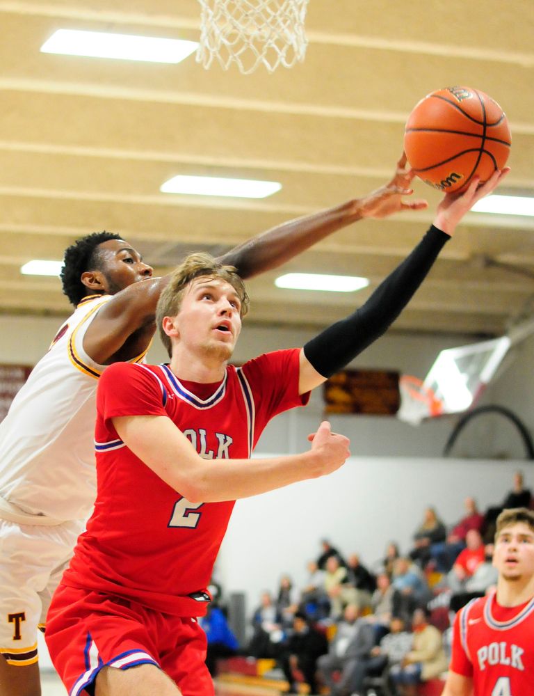 Staff Photo by Robin Rudd / Tyner's Keelan Jackson (13) just gets his hand on Polk's Caleb Milen's (2) shot. The Polk County Wildcats visited the Tyner Rams in TSSAA boy's basketball on December 7, 2021.