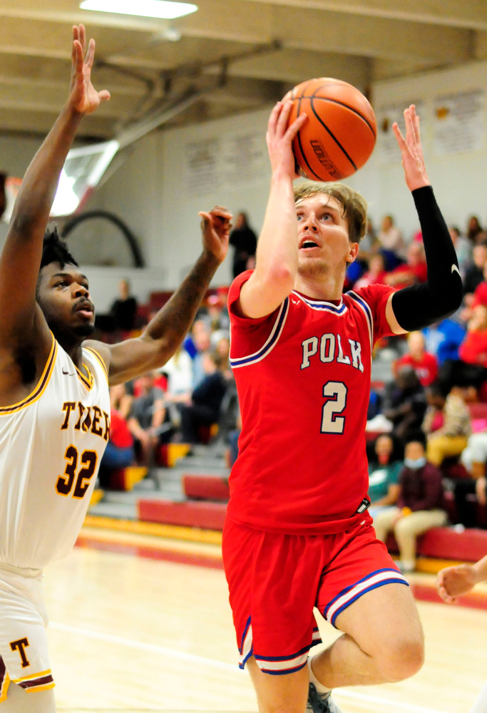 Staff Photo by Robin Rudd / Polk's Caleb Milen (2) scores past Tyner's Anthony Sims (32). The Polk County Wildcats visited the Tyner Rams in TSSAA boy's basketball on December 7, 2021.