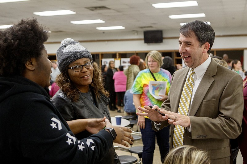 Staff file photo / Chattanooga High Center for Creative Arts junior MaCia Rudolph, left, and her mom Gloria speak with Hamilton County Schools Chief Operations Officer Justin Robertson, right, during a community forum at Tyner Academy in 2020. On Tuesday, Robertson was the third finalist to interview for the district's superintendent opening.