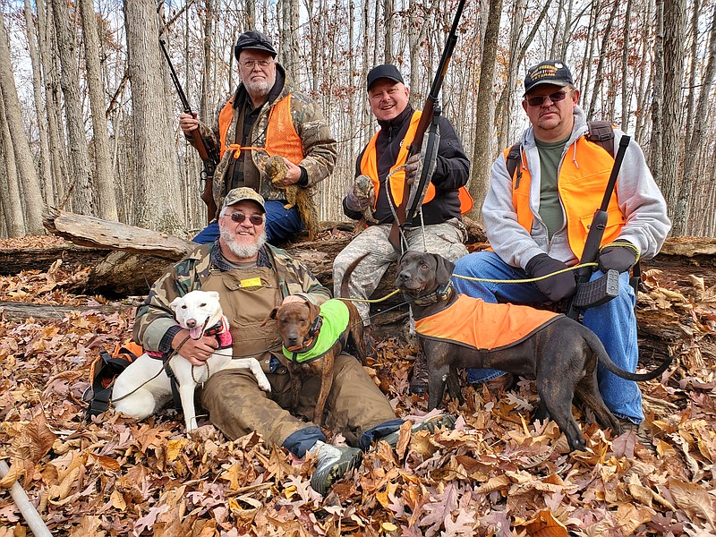 Photo contributed by Larry Case / Ronnie Snedegar, bottom left, put his squirrel hunting dogs to work during a recent outing with The Fallen Outdoors, which provides hunting and fishing adventures for members of the U.S. military, both active duty and veterans. On back row from left are TFO pro staffer Ronald Bennett and TFO participants Sam Goings and Clint Smith.
