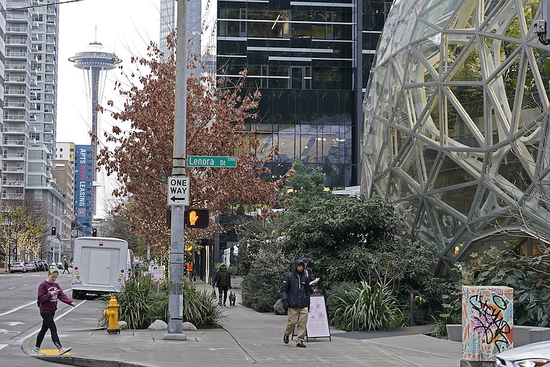 The Amazon Spheres on the company's corporate campus are shown near the Space Needle in downtown Seattle, Tuesday, Dec. 7, 2021. Amazon Web Services suffered a major outage Tuesday, the company said, disrupting access to many popular sites. The company provides cloud computing services to many governments, universities and companies, including The Associated Press. (AP Photo/Ted S. Warren)
