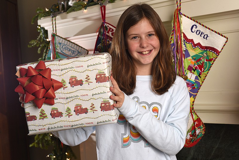 Staff Photo by Matt Hamilton / Cora Stowe, 11, with her wrapping paper design at her home on Signal Mountain.