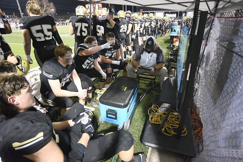 Staff photo by Matt Hamilton / Calhoun High School offensive linemen review video during their GHSA Class AAAAA semifinal against Blessed Trinity on Dec. 3. Calhoun won 24-7 to improve to 12-2 and will face Warner Robins (13-1) for the title at 3:30 p.m. Saturday at Center Parc Stadium in Atlanta.