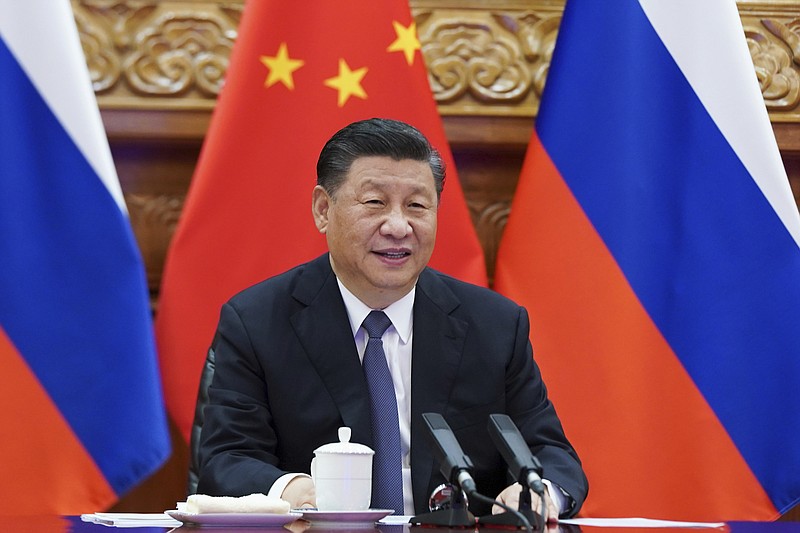 File photo by Xie Huanchi/Xinhua via The Associated Press / In this photo released by Xinhua News Agency, Chinese President Xi Jinping talks with Russian President Vladimir Putin, on the screen, via video conference in Beijing, on Monday, June 28, 2021.